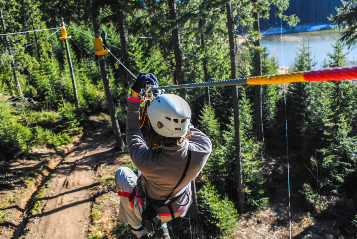 Woman sliding on a zip line in an adventure park (Shutterstock) Woman sliding on a zip line in an adventure park (Shutterstock)