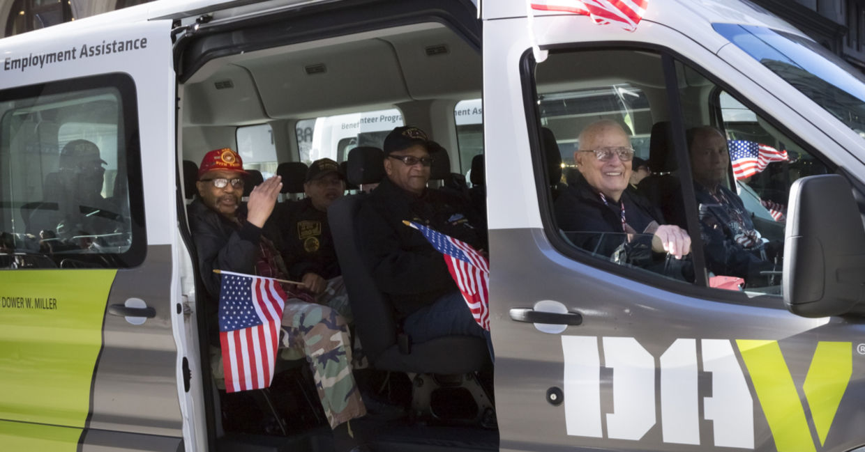 Vets wave the American Flag from the DAV, Disabled American Veterans, van during the 2016 annual America's Parade held on Veterans Day in Manhattan Vets wave the American Flag from the DAV, Disabled American Veterans, van during the 2016 annual America's Parade held on Veterans Day in Manhattan