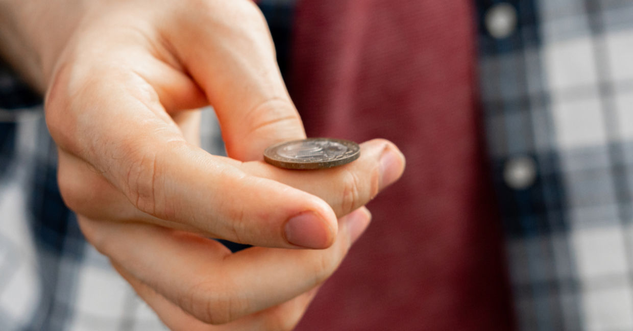 A man flips a coin, connecting with his sixth sense.
