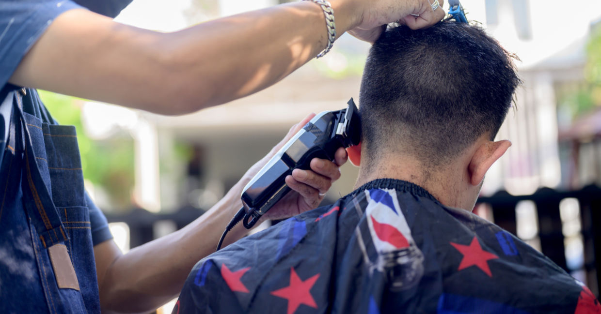 Cutting hair outside. Cutting hair outside.