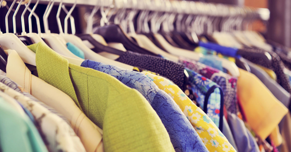 Closet full of clothes on different colored hangers