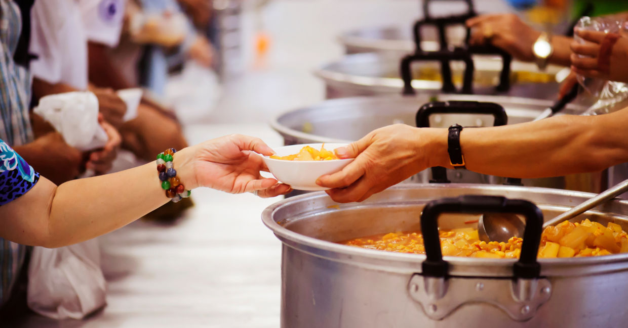 Serving food to the needy at a soup kitchen.