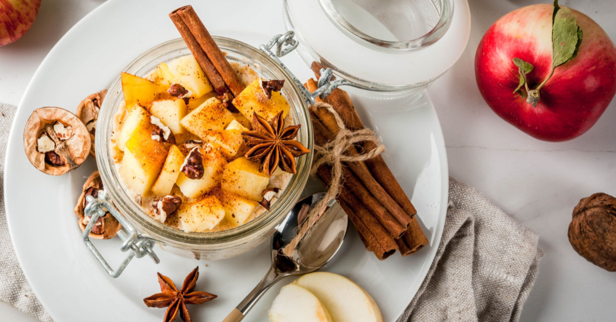 Apple pie overnight oats in a glass jar with cinnamon stick and walnuts. Apple pie overnight oats in a glass jar with cinnamon stick and walnuts.