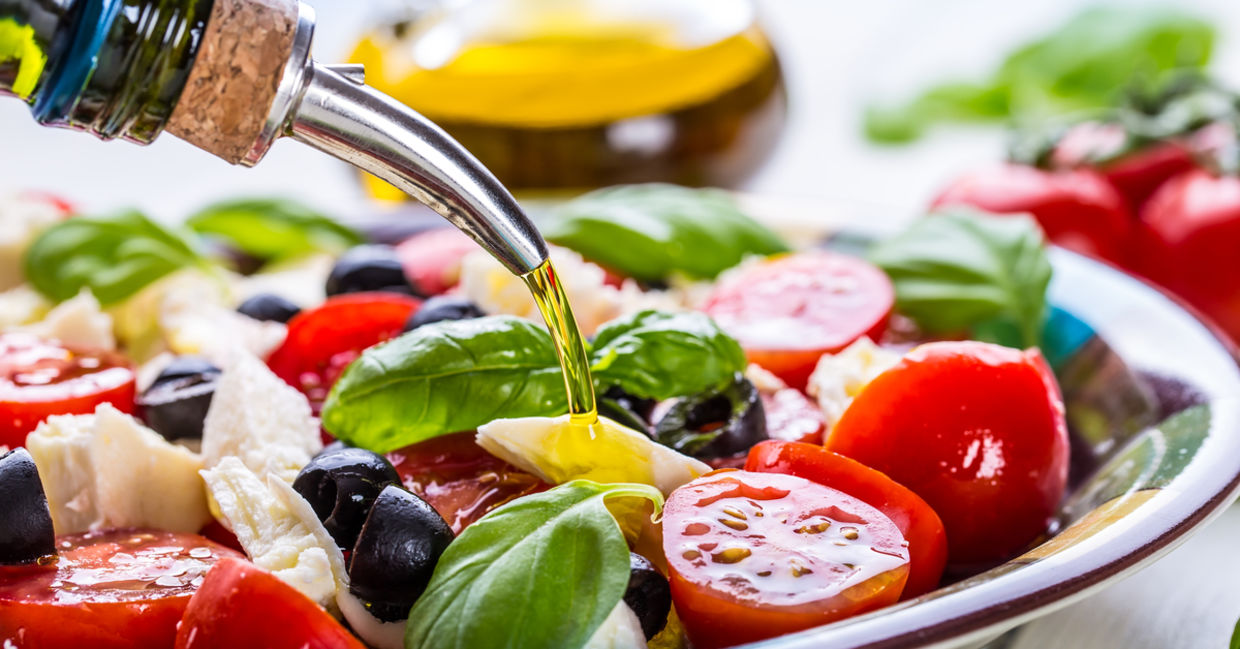 Healthy olive oil on a fresh green salad. Healthy olive oil on a fresh green salad.