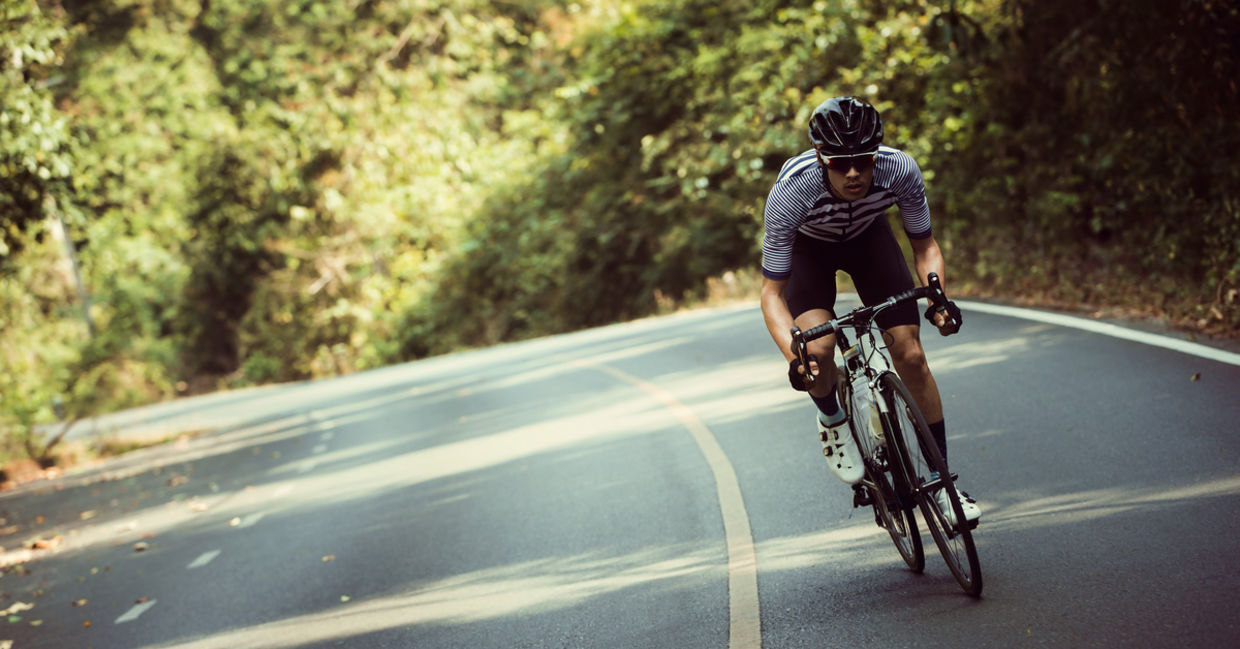 Man riding bicycle on road. Man riding bicycle on road.