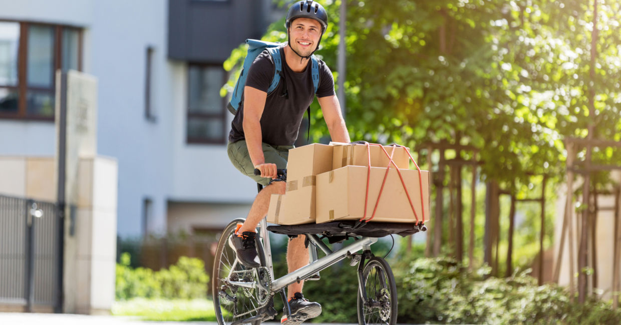 Bicycle messenger making a delivery on a cargo bike Bicycle messenger making a delivery on a cargo bike