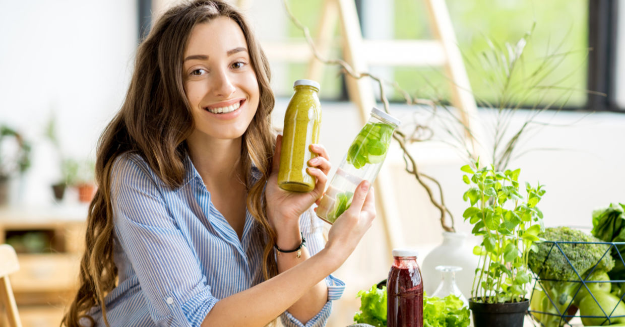 A woman doing a detox shows her healthy smoothies along with detoxifying fruits and vegetables.