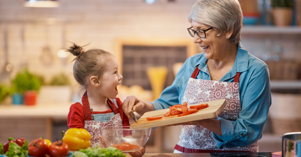 A grandma conveys love to her granddaughter as they cook together, an act of tsavd tanem. A grandma conveys love to her granddaughter as they cook together, an act of tsavd tanem.