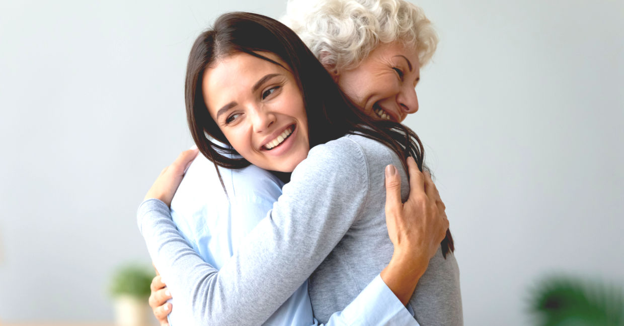 Young granddaughter hugging her grandmother.