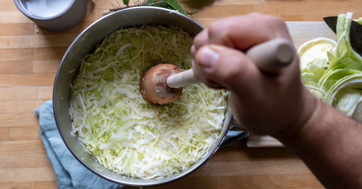 Making sauerkraut by tamping it down. Making sauerkraut by tamping it down.
