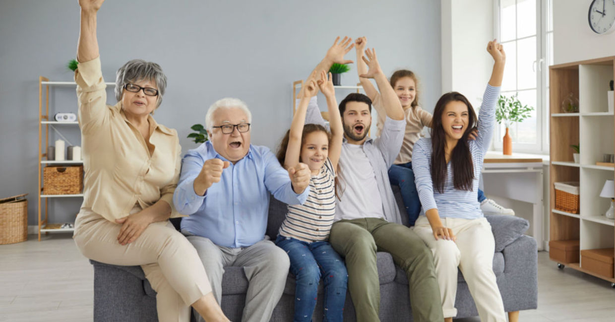 A family watches TV together. A family watches TV together.