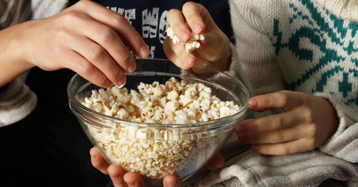 Watching a movie while enjoying popcorn. Watching a movie while enjoying popcorn.