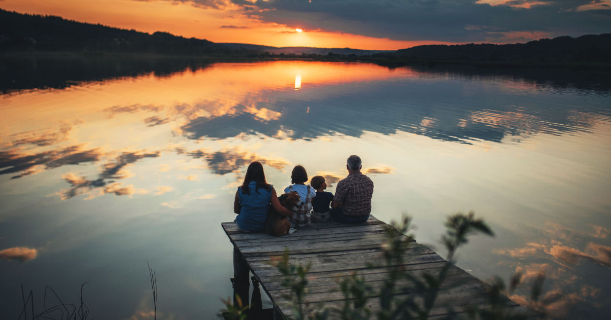 A family sitting on a bridge. A family sitting on a bridge.