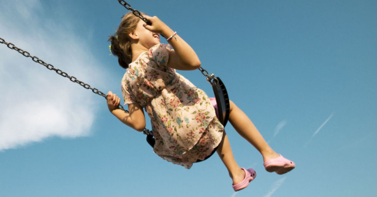 A woman enjoying a swing is a simple pleasure. A woman enjoying a swing is a simple pleasure.