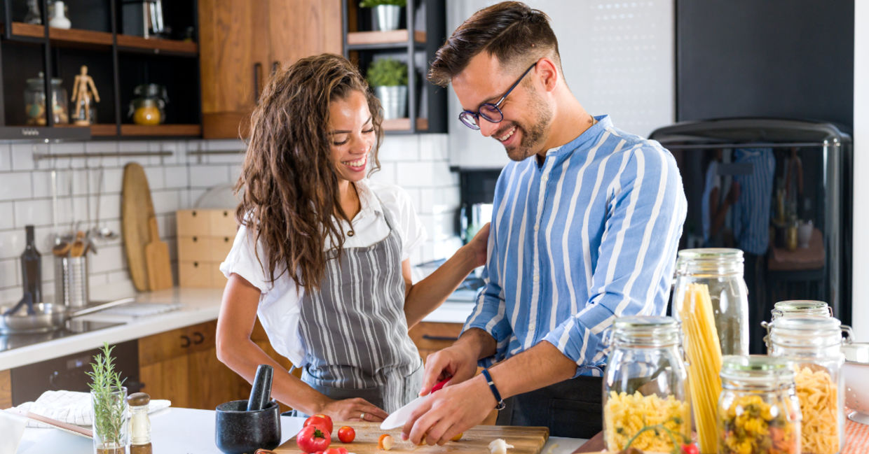 A couple cooking together. A couple cooking together.