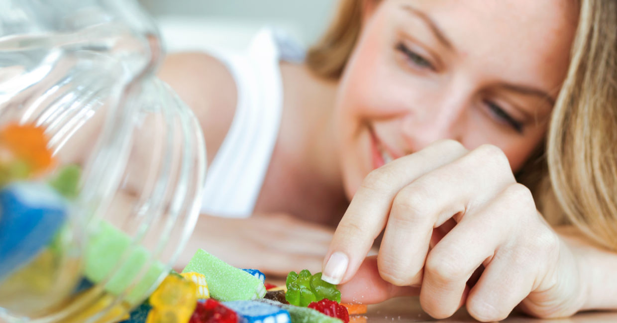 A woman eating jelly candies. A woman eating jelly candies.