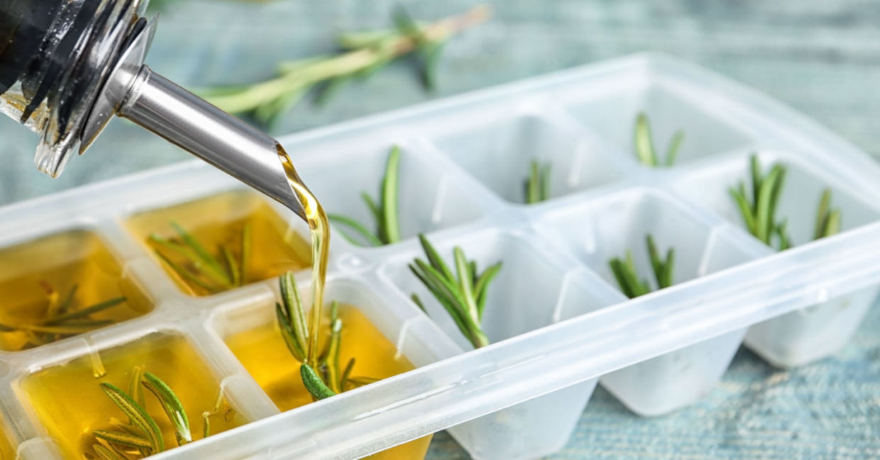 Freezing rosemary in olive oil in an ice cube tray. Freezing rosemary in olive oil in an ice cube tray.