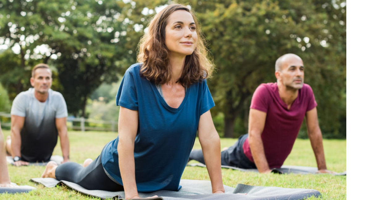 Yoga stretching in a park,