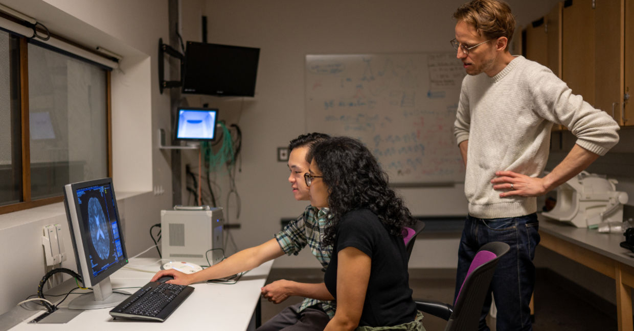 researchers looking at brain scans.