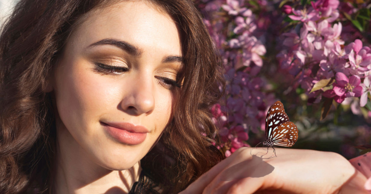 Woman holding a butterfly.
