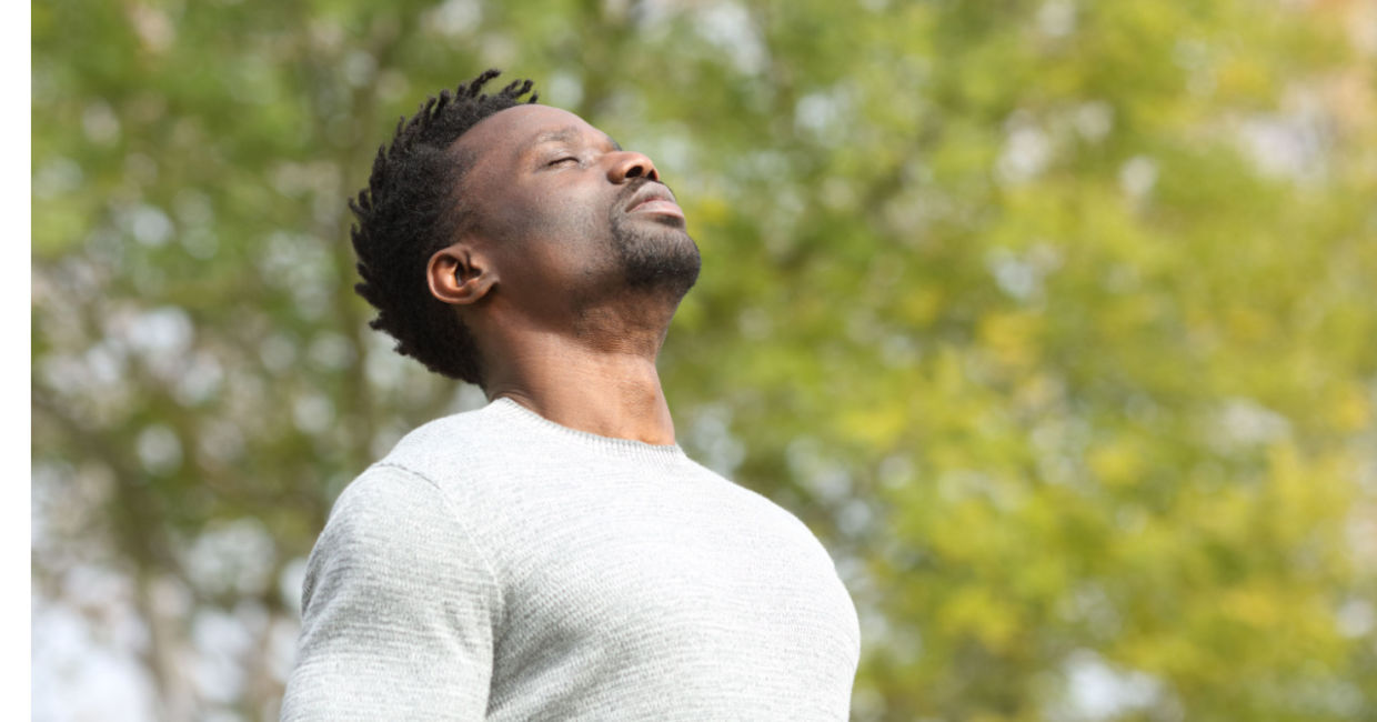 Man doing a deep breathing exercise. Man doing a deep breathing exercise.