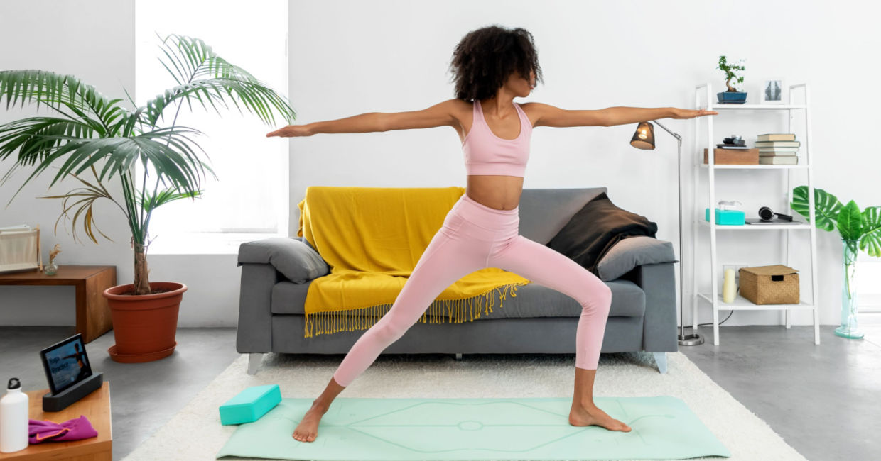 Woman standing tall in the Warrior II yoga pose. Woman standing tall in the Warrior II yoga pose.