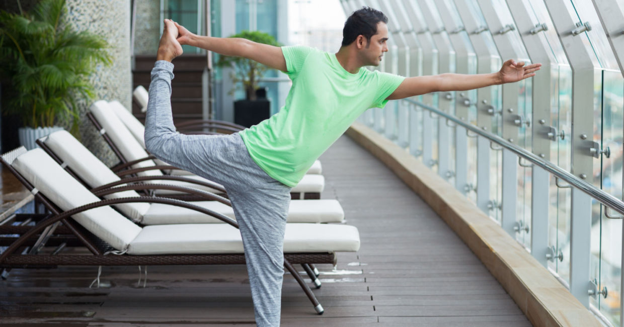 man doing the dancing shiva yoga pose. man doing the dancing shiva yoga pose.