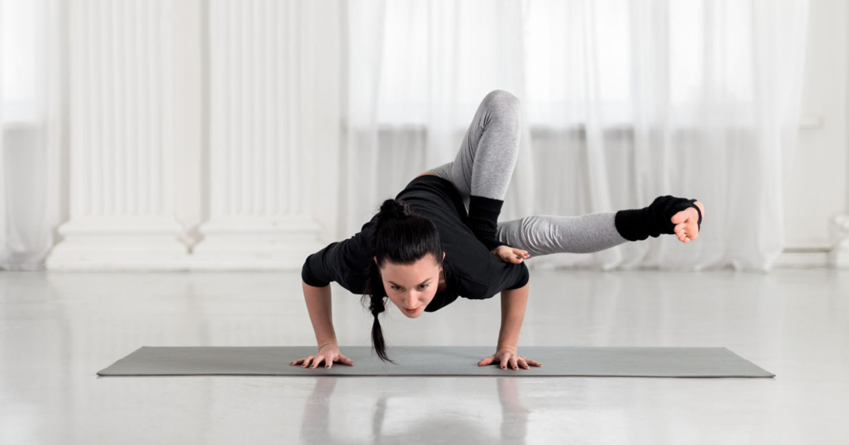 Practicing the dragonfly yoga pose.