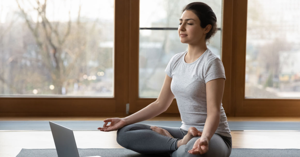 Woman beginning a series of yoga poses to help her get over a cold. Woman beginning a series of yoga poses to help her get over a cold.