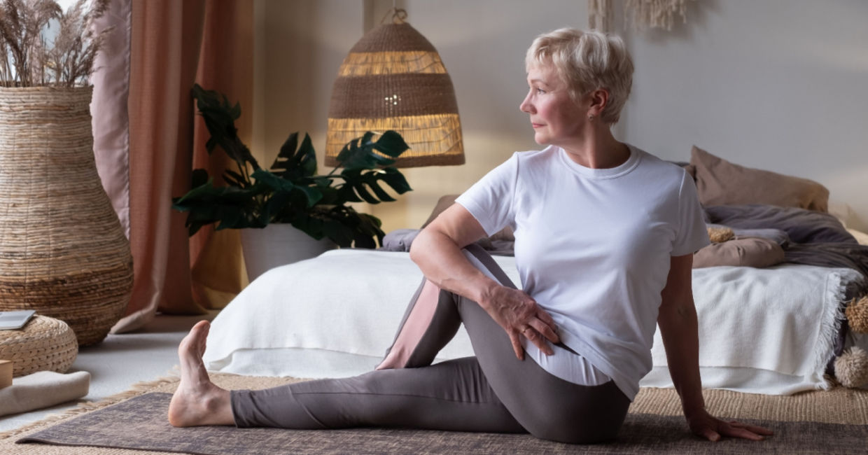 Woman in the seated spinal twist yoga pose. Woman in the seated spinal twist yoga pose.