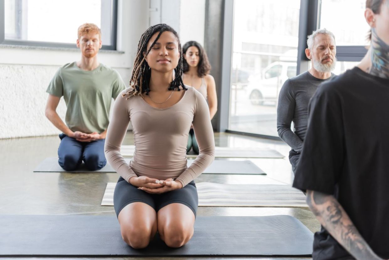 Yoga class practicing the thunderbolt pose.