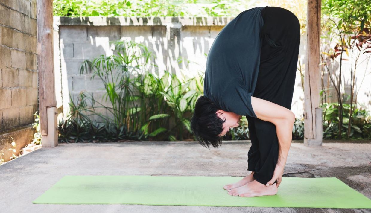 Man in the hasta uttanasanam yoga pose. Man in the hasta uttanasanam yoga pose.
