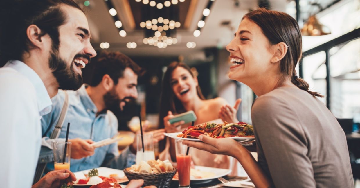 A group of happy friends eating out. A group of happy friends eating out.