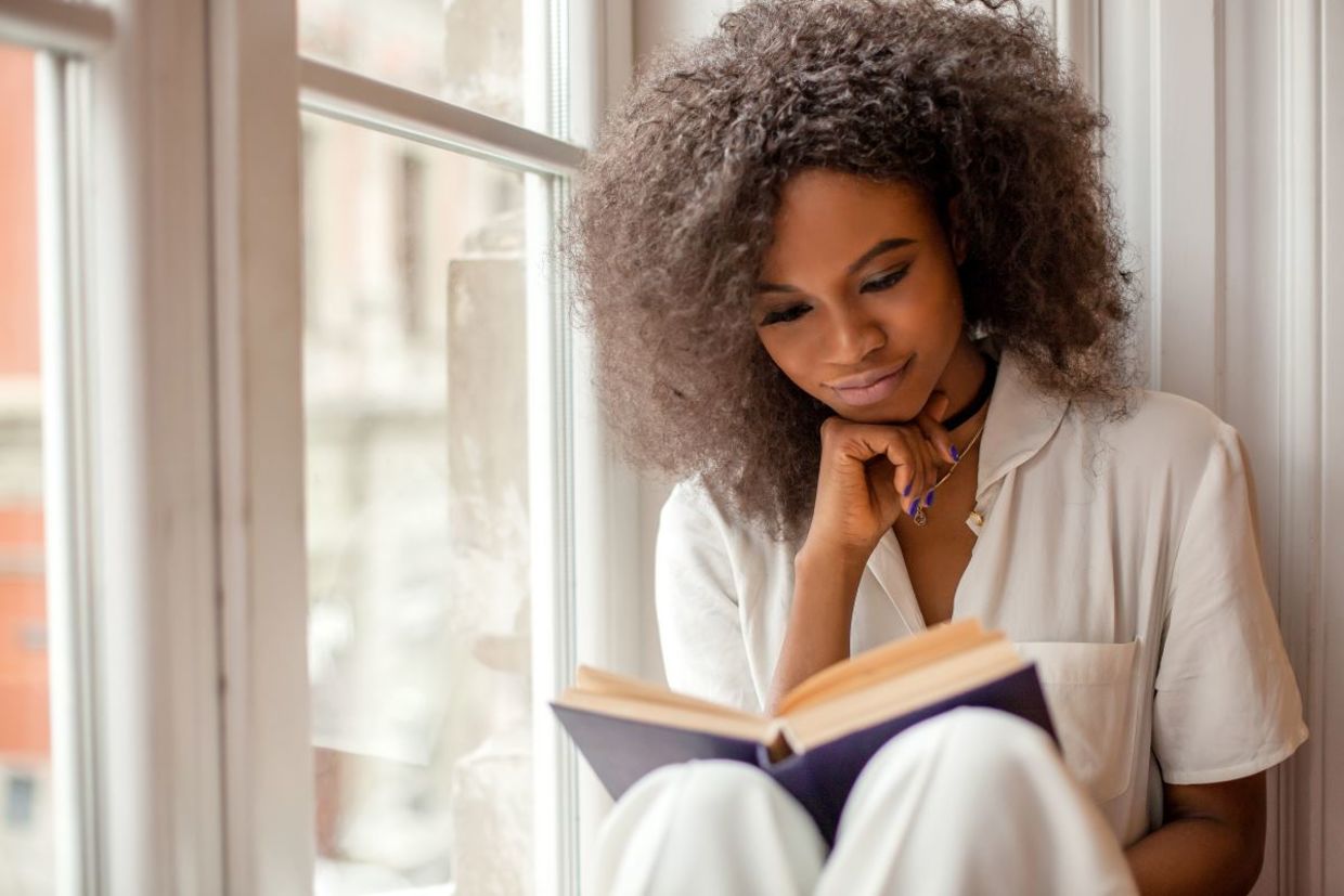a woman engrossed in a good book. a woman engrossed in a good book.