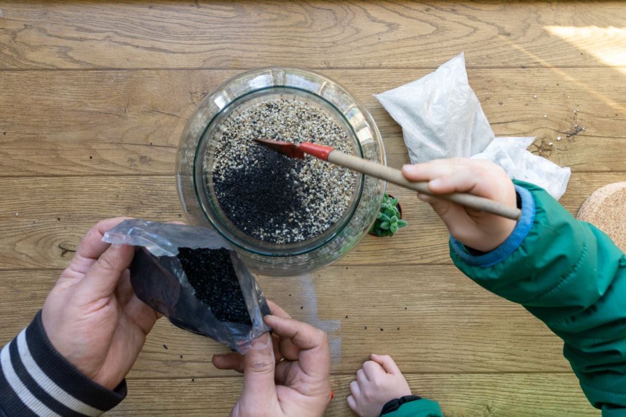 Using stones for drainage in a terrarium. Using stones for drainage in a terrarium.