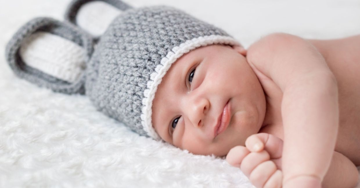 Cute newborn on a white blanket. Cute newborn on a white blanket.