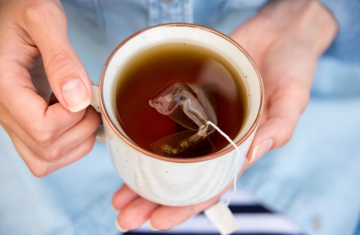 Enjoying a cup of hot tea.