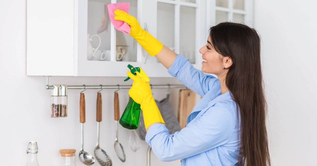 Woman spring cleaning her home. Woman spring cleaning her home.