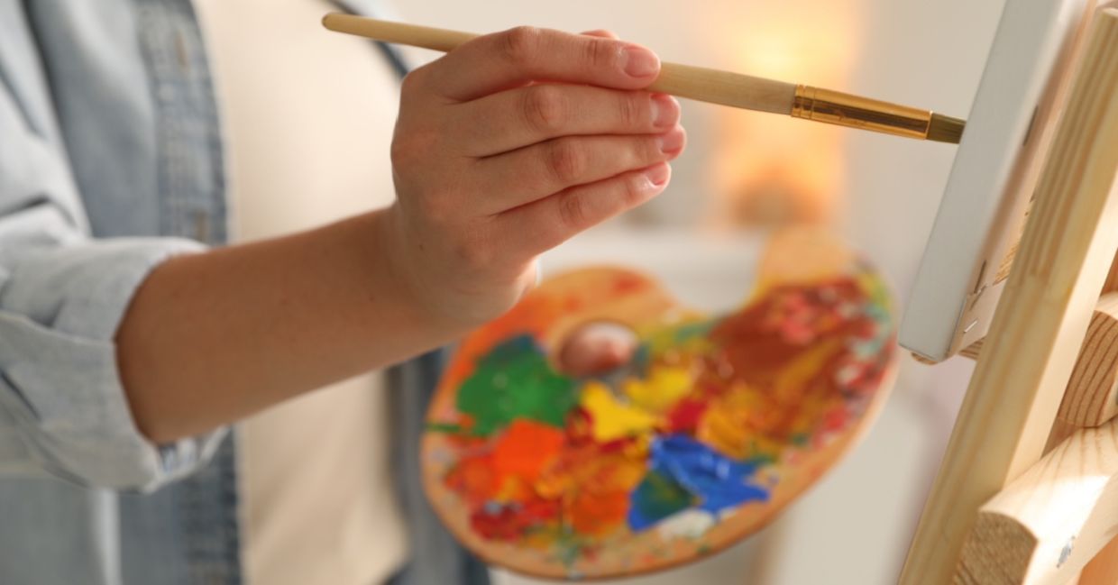 An artist painting a canvas. An artist painting a canvas.