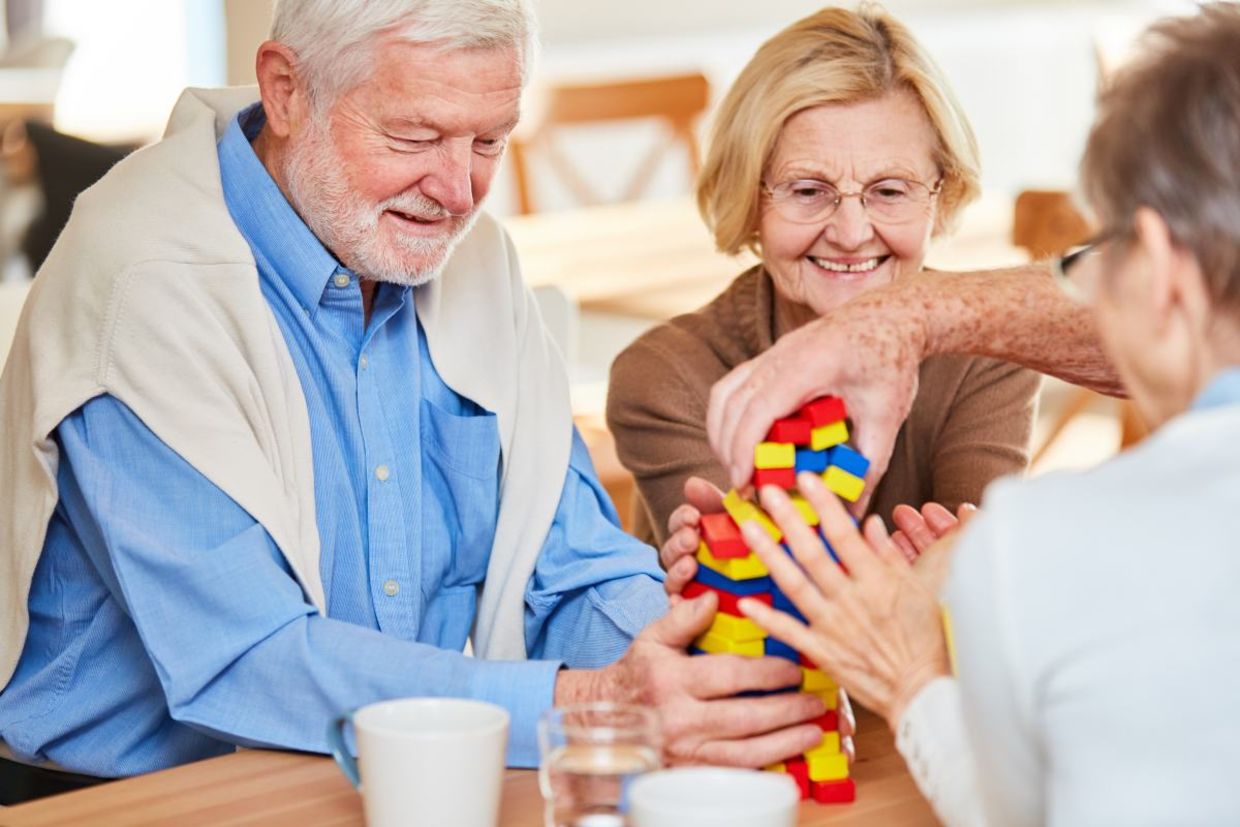 Seniors with dementia interacting at a memory cafe. Seniors with dementia interacting at a memory cafe.