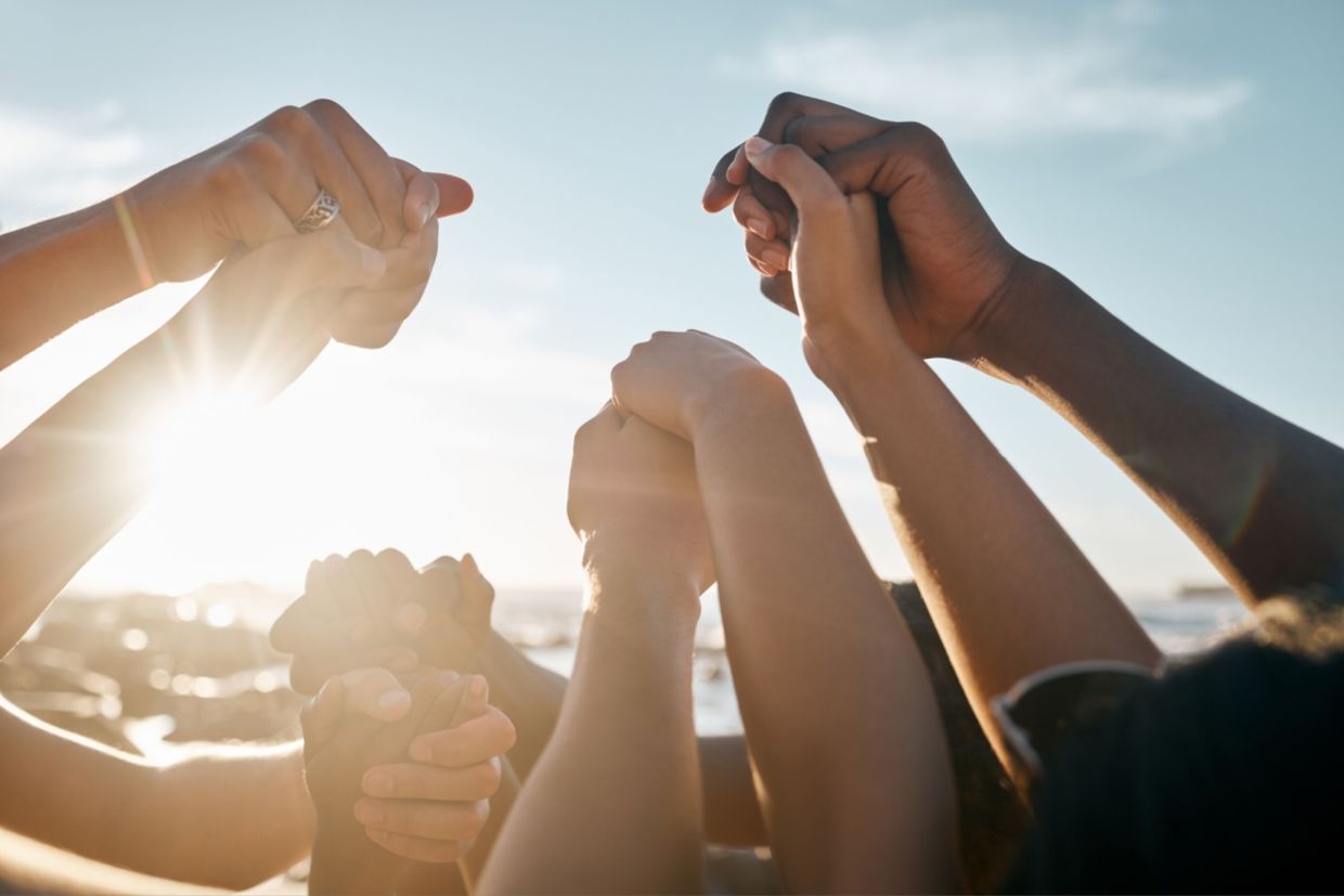 A group of people holding hands. A group of people holding hands.